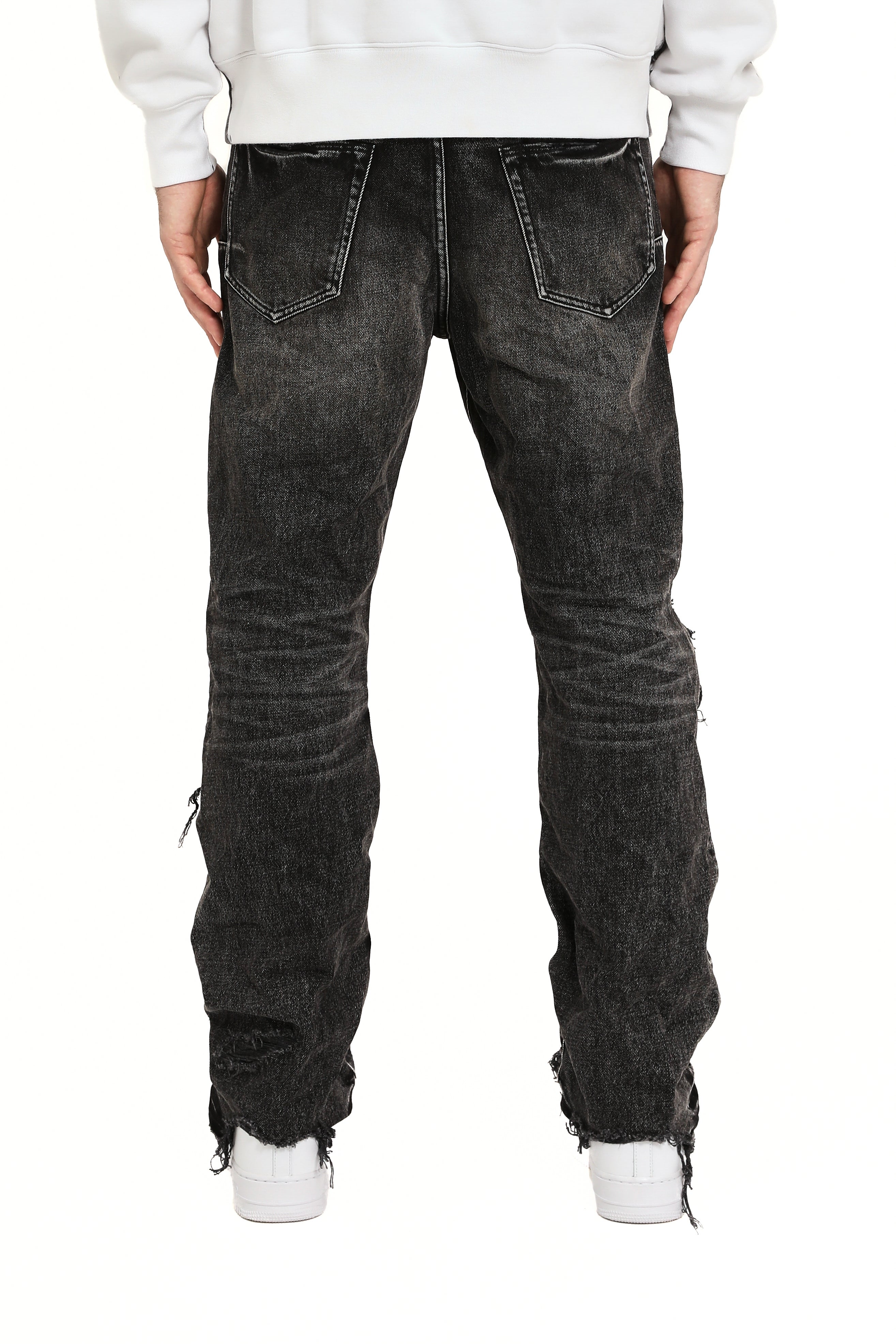 Purple Brand Repair Blowout Jeans in black denim featuring heavy distressing, repaired blowout details, and slim tapered fit.