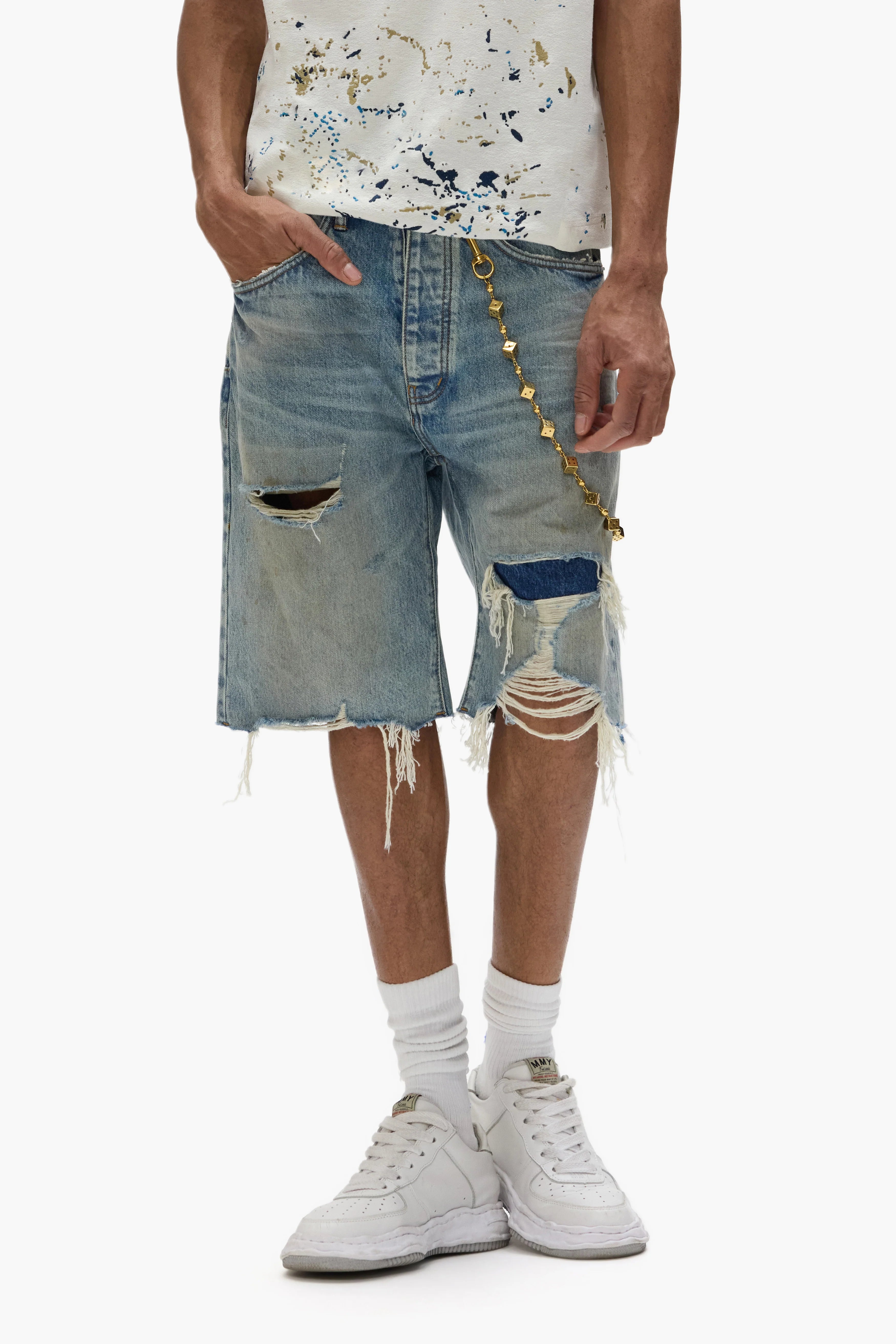 Purple Brand P059 Cutoff Denim Shorts in light indigo with rip-and-repair distressing, frayed hems, and signature leather patch detailing.