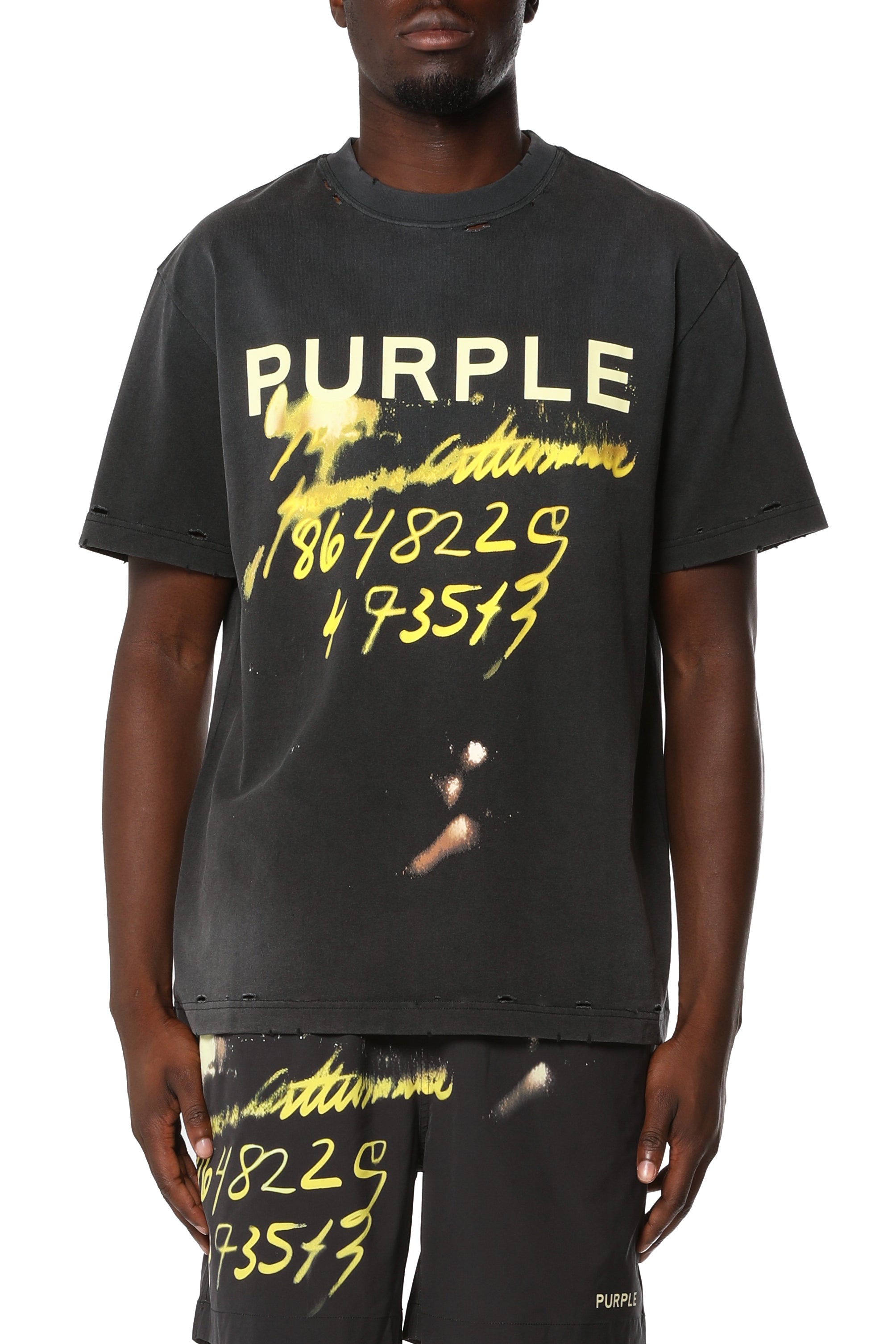 Purple Brand heavyweight cotton graphic T-shirt featuring a distressed finish with nicks, holes, heavy fading, bleach stains, and neon graphic detailing.