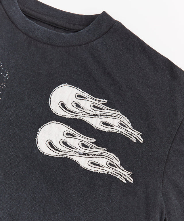 Black Trouble Applique short sleeve tee with back graphic print and embroidered details.