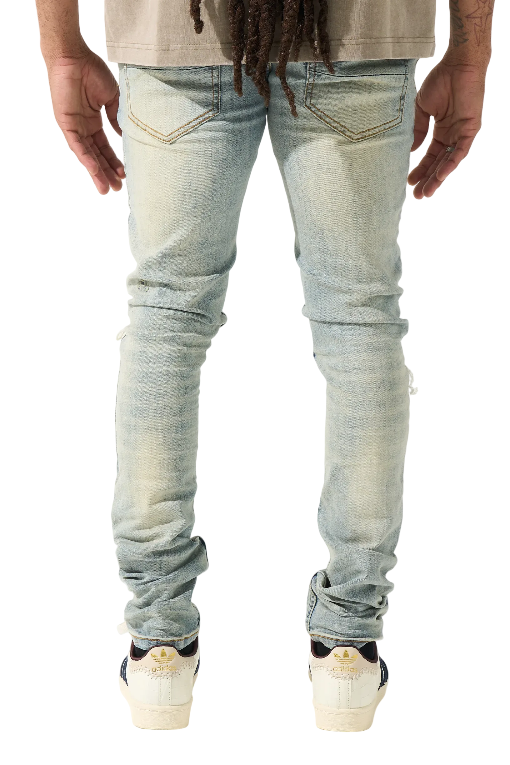 SERENEDE vintage earth wash skinny jeans with heavy fading, distressed details, and a tapered streetwear silhouette.