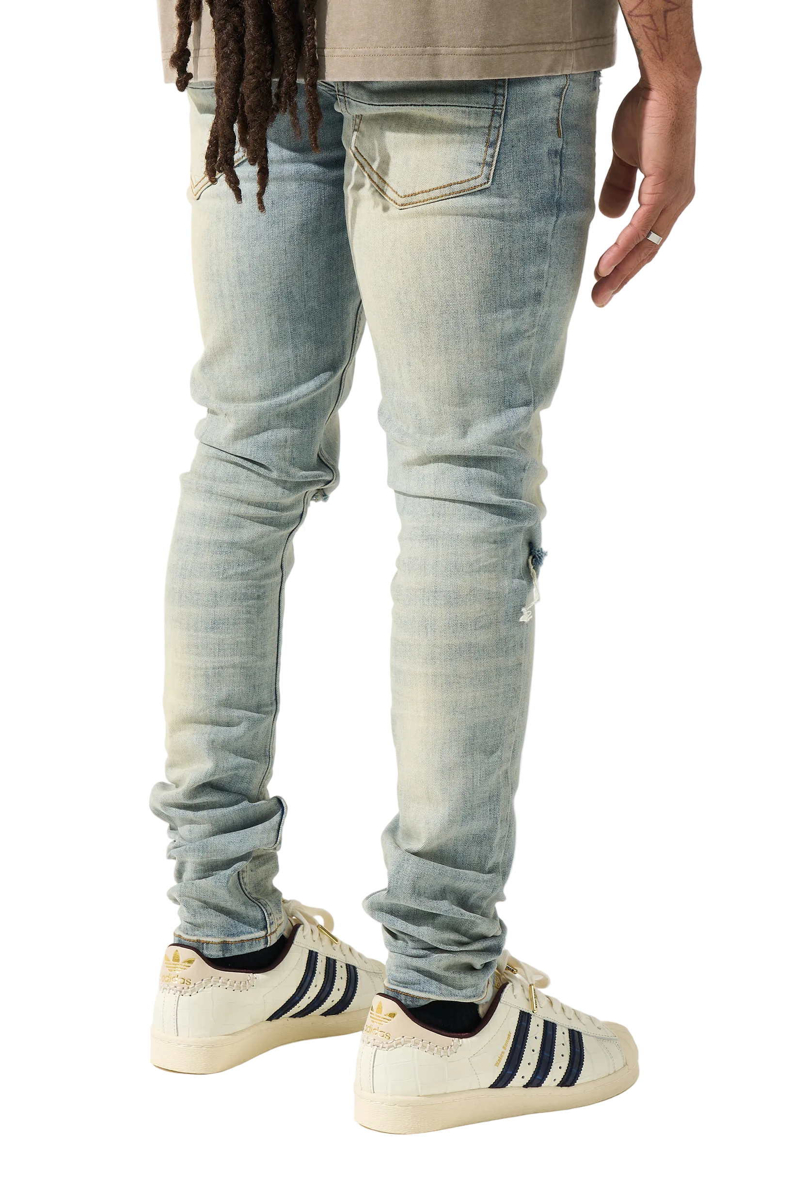 SERENEDE vintage earth wash skinny jeans with heavy fading, distressed details, and a tapered streetwear silhouette.