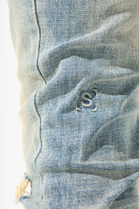 SERENEDE® SEDONA 2.0 vintage earth tone skinny jeans with high-stretch fabric, fading and distressing, tapered ankles, leather waistband patch, and branded hardware