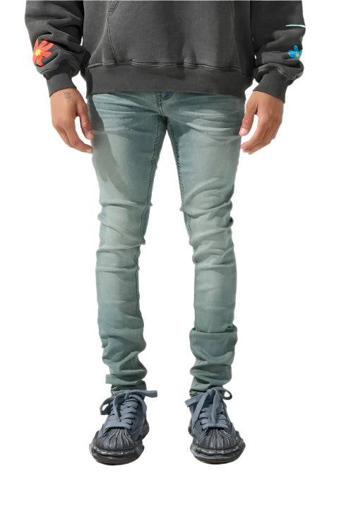 Slate blue skinny fit denim with fading, distressing, leather waistband patch, and SERENEDE® branded hardware.