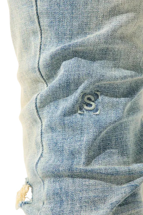 SERENEDE vintage earth wash skinny jeans with heavy fading, distressed details, and a tapered streetwear silhouette.