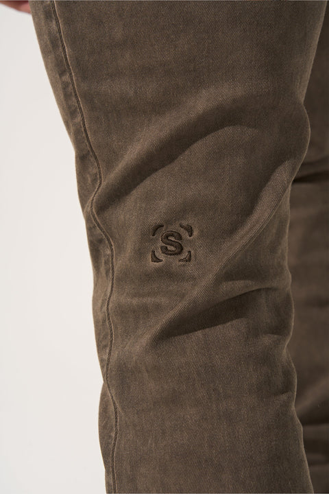 SERENEDE® SARLAT brown overdyed stacked jeans with fitted construction, extended length, multi-sized gems, leather waistband patch, holographic hangtag, and branded hardware