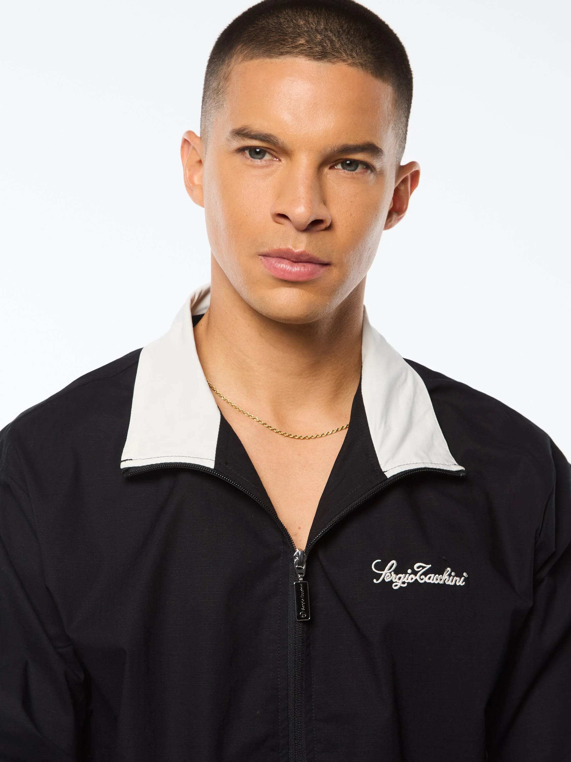 Premium track jacket with embroidered Sergio Tacchini logo, full-zip closure, contrast piping panels, and welt handwarmer pockets
