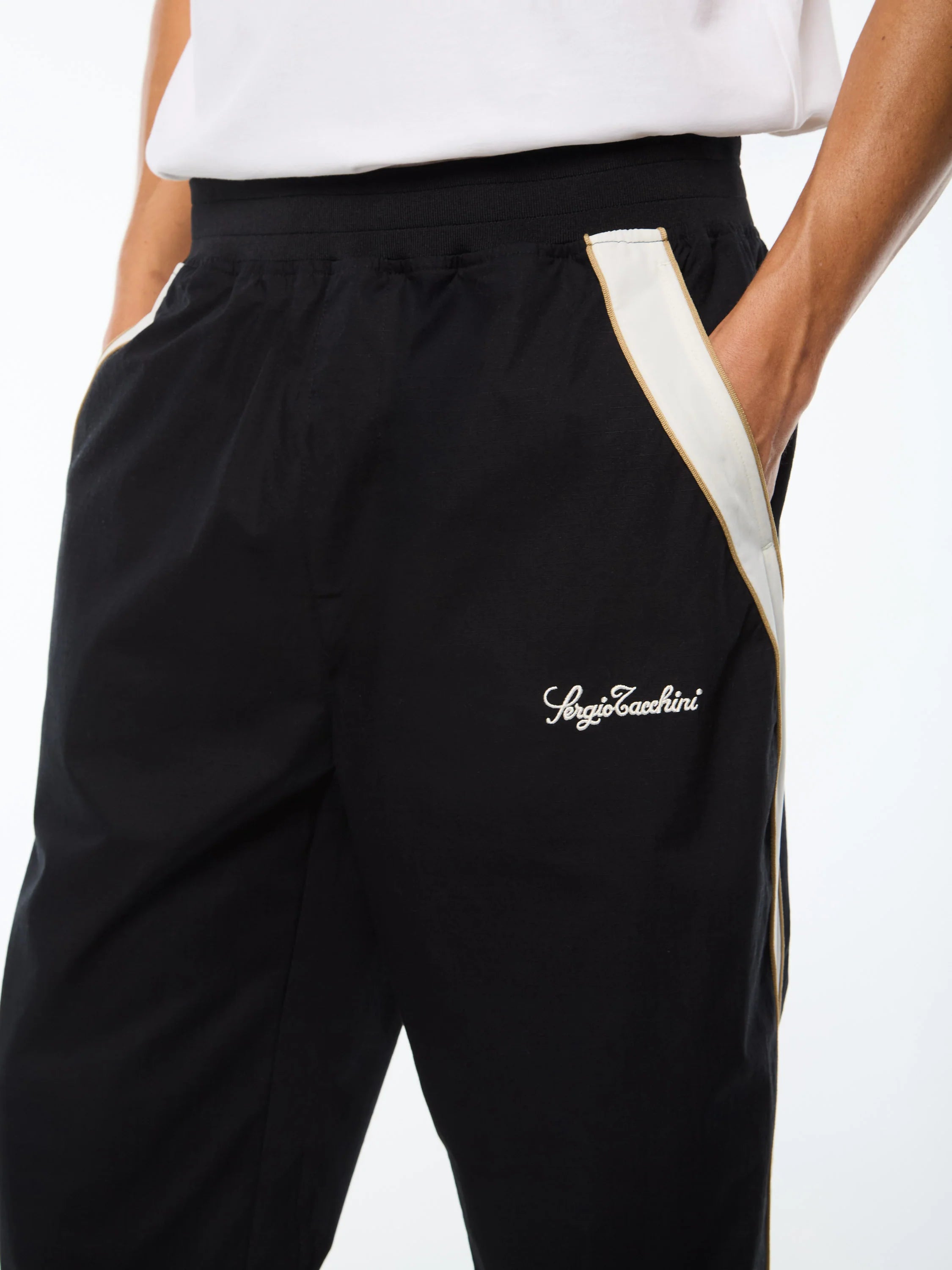 Premium track pants with embroidered Sergio Tacchini logo, elastic waistband, contrast piping down legs, and adjustable ankle zips