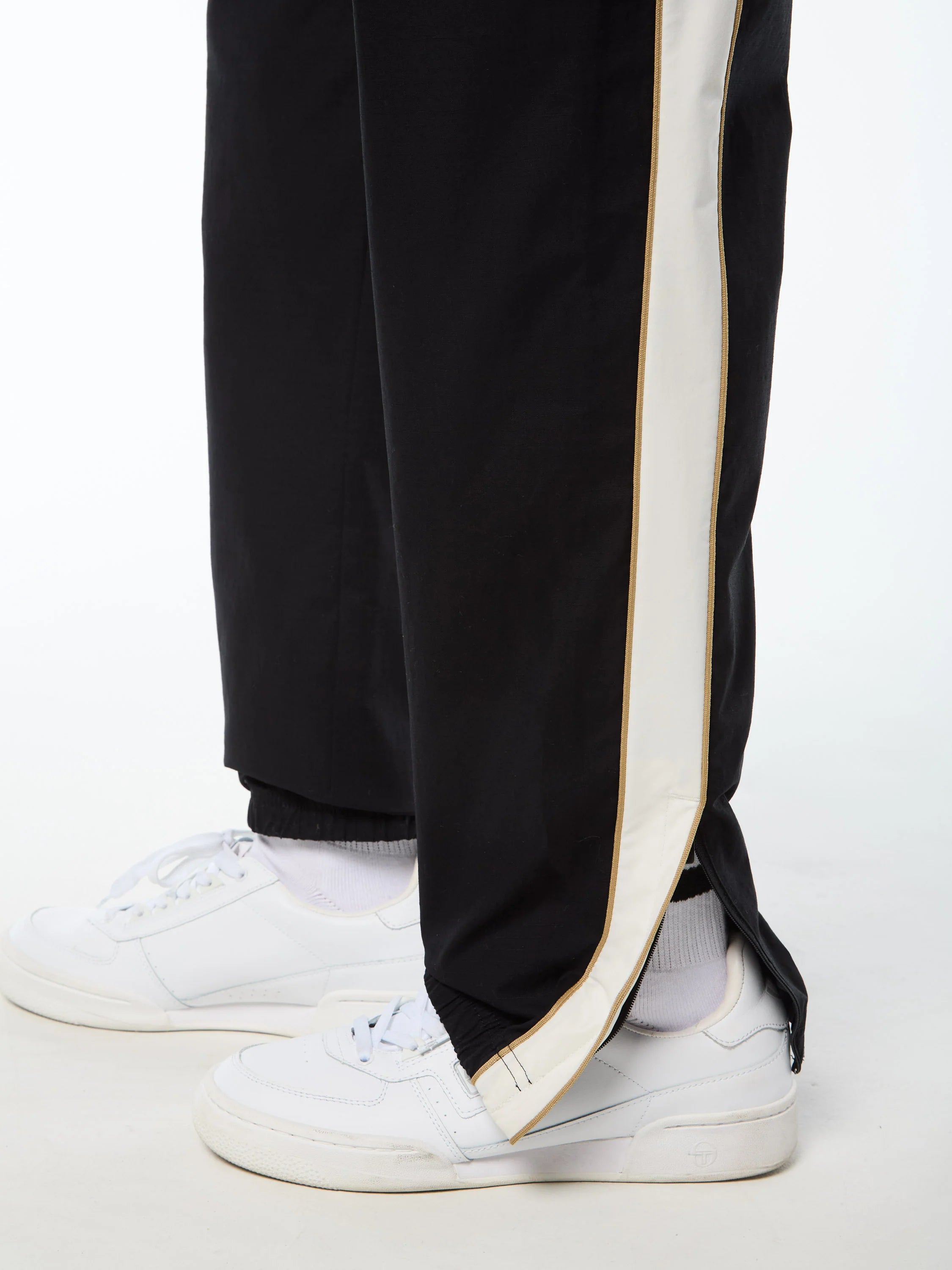 Premium track pants with embroidered Sergio Tacchini logo, elastic waistband, contrast piping down legs, and adjustable ankle zips