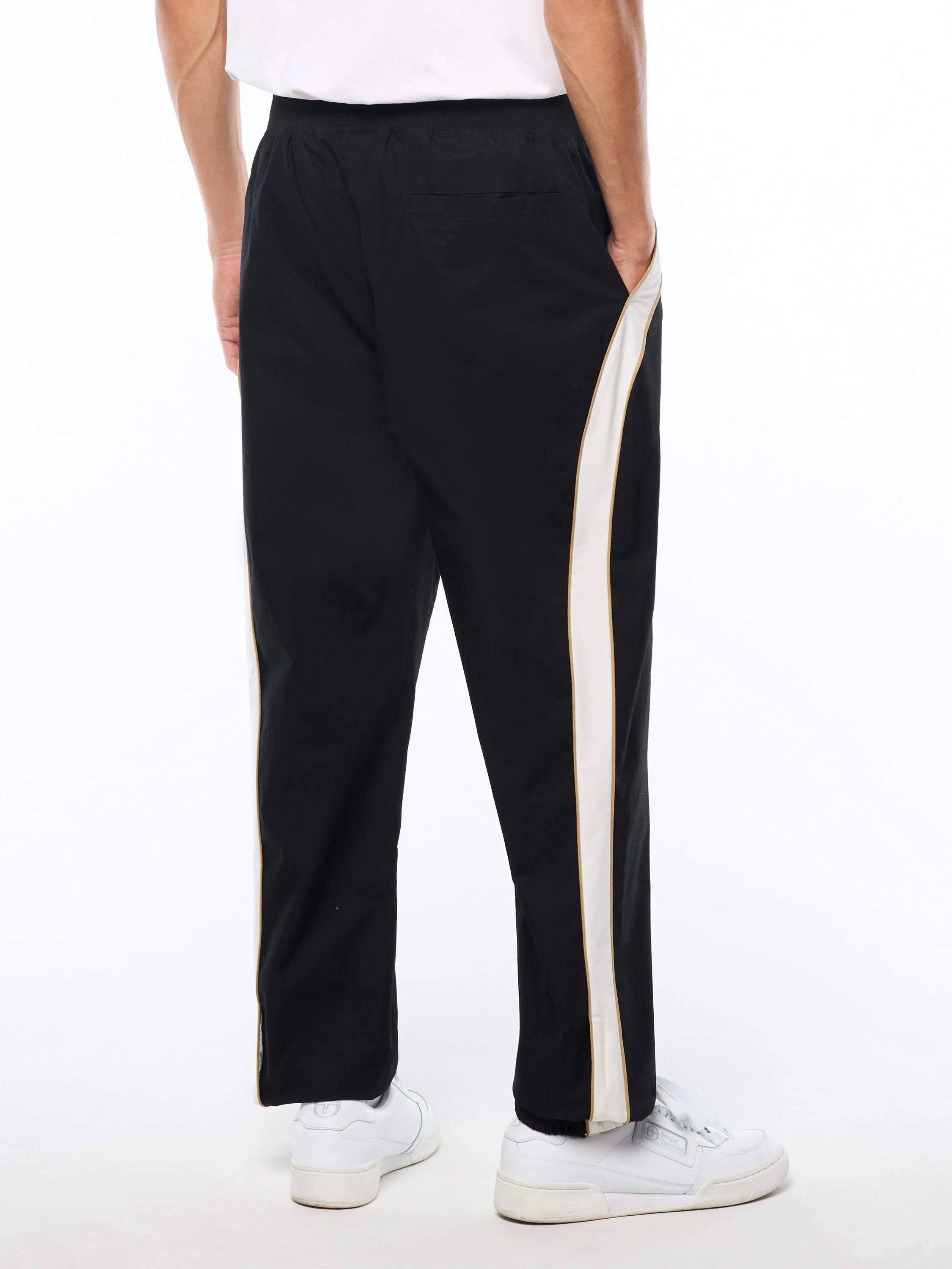 Premium track pants with embroidered Sergio Tacchini logo, elastic waistband, contrast piping down legs, and adjustable ankle zips