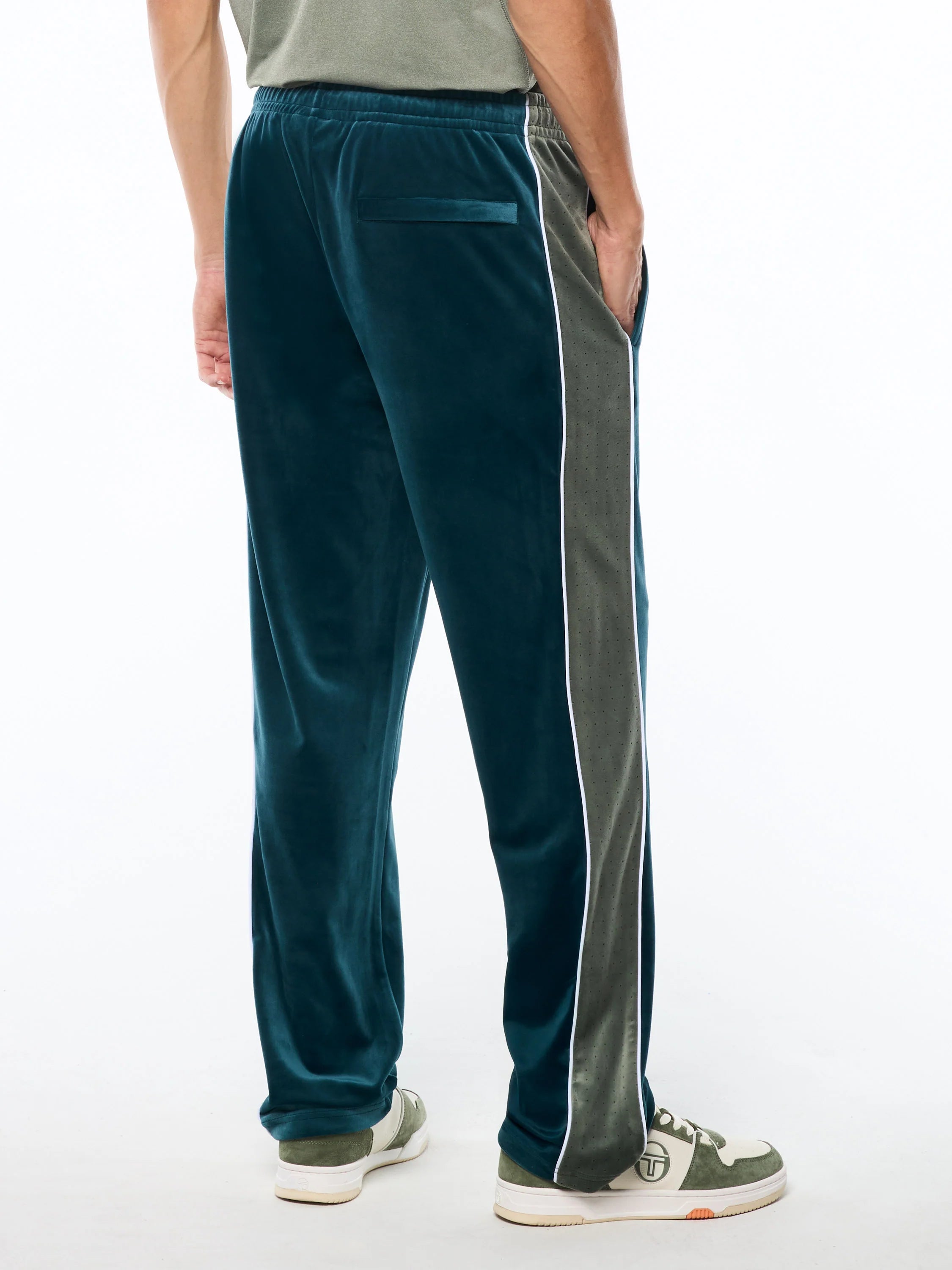 Premium velour track pants with elastic waistband, internal drawstring, side piping details, and embroidered ST monogram logo