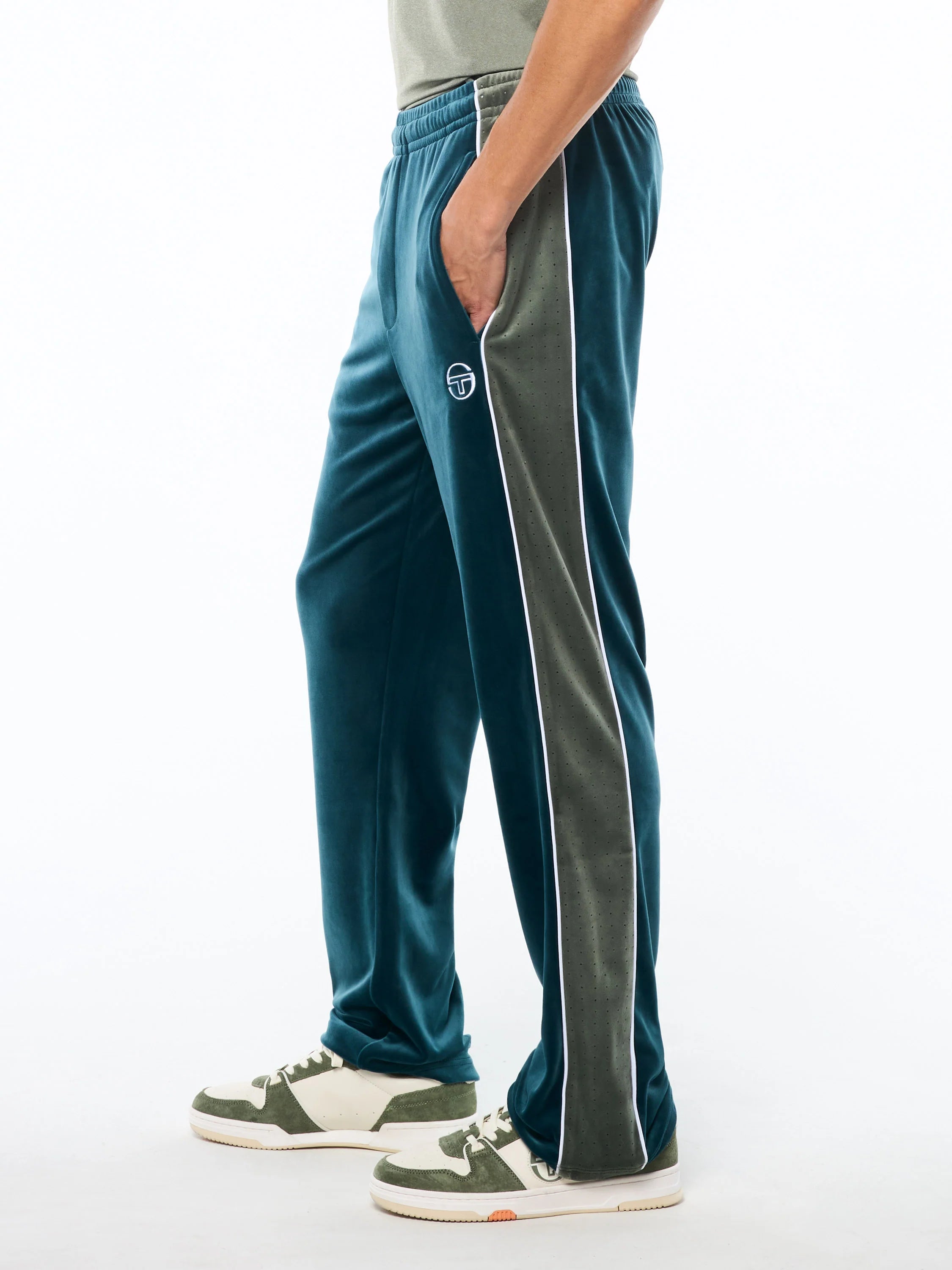 Premium velour track pants with elastic waistband, internal drawstring, side piping details, and embroidered ST monogram logo