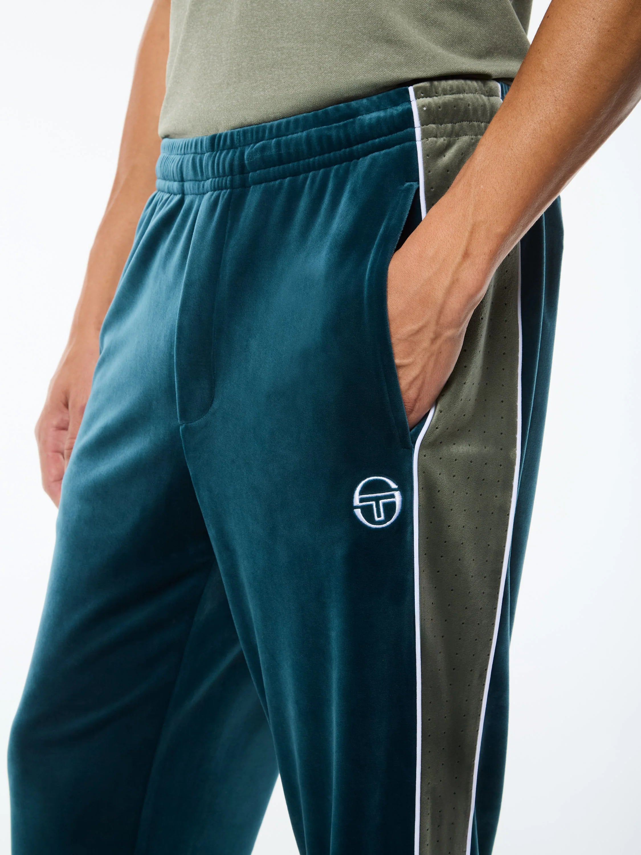 Premium velour track pants with elastic waistband, internal drawstring, side piping details, and embroidered ST monogram logo