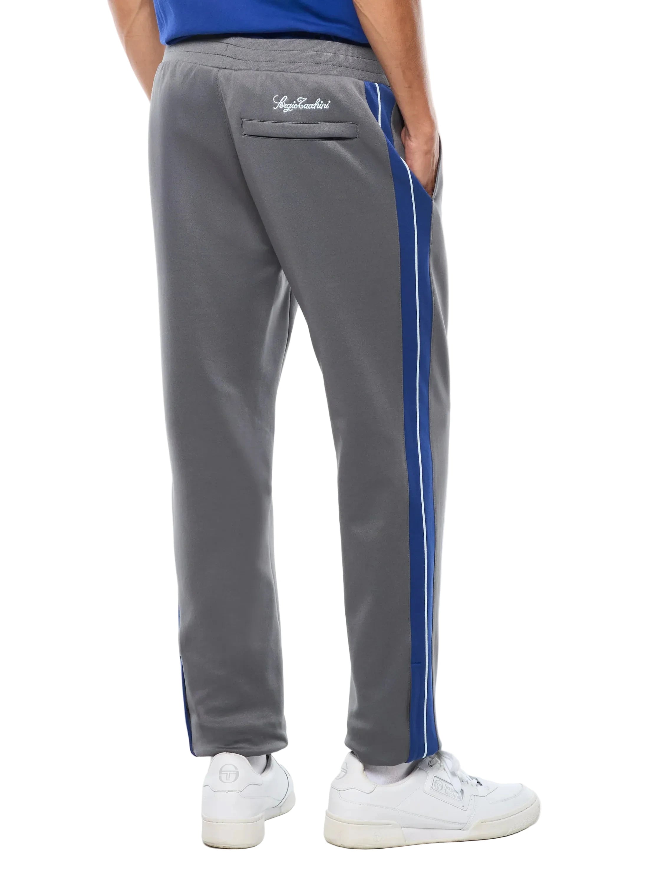 Premium track pants with elastic waistband, rear zippered welt pocket, embroidered Sergio Tacchini logo, contrast panels and piping down legs, and adjustable ankle zips