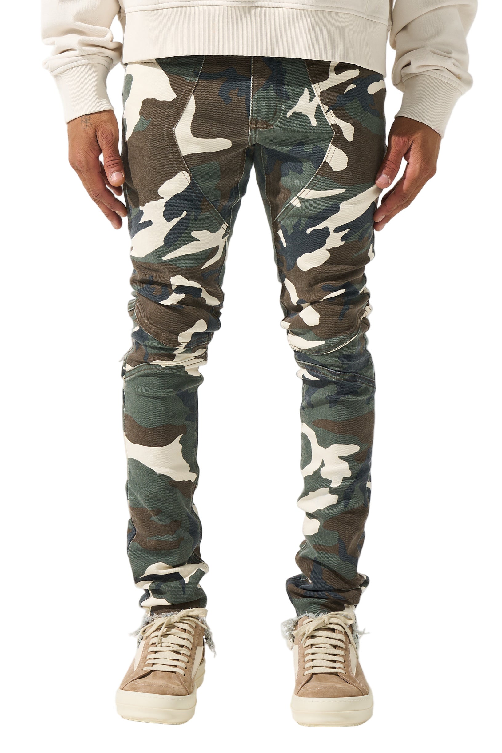 SERENEDE® SYNC Jeans in desert moss camo with fitted construction, biker panel details, embroidered [S]® logo, and holographic hangtag.