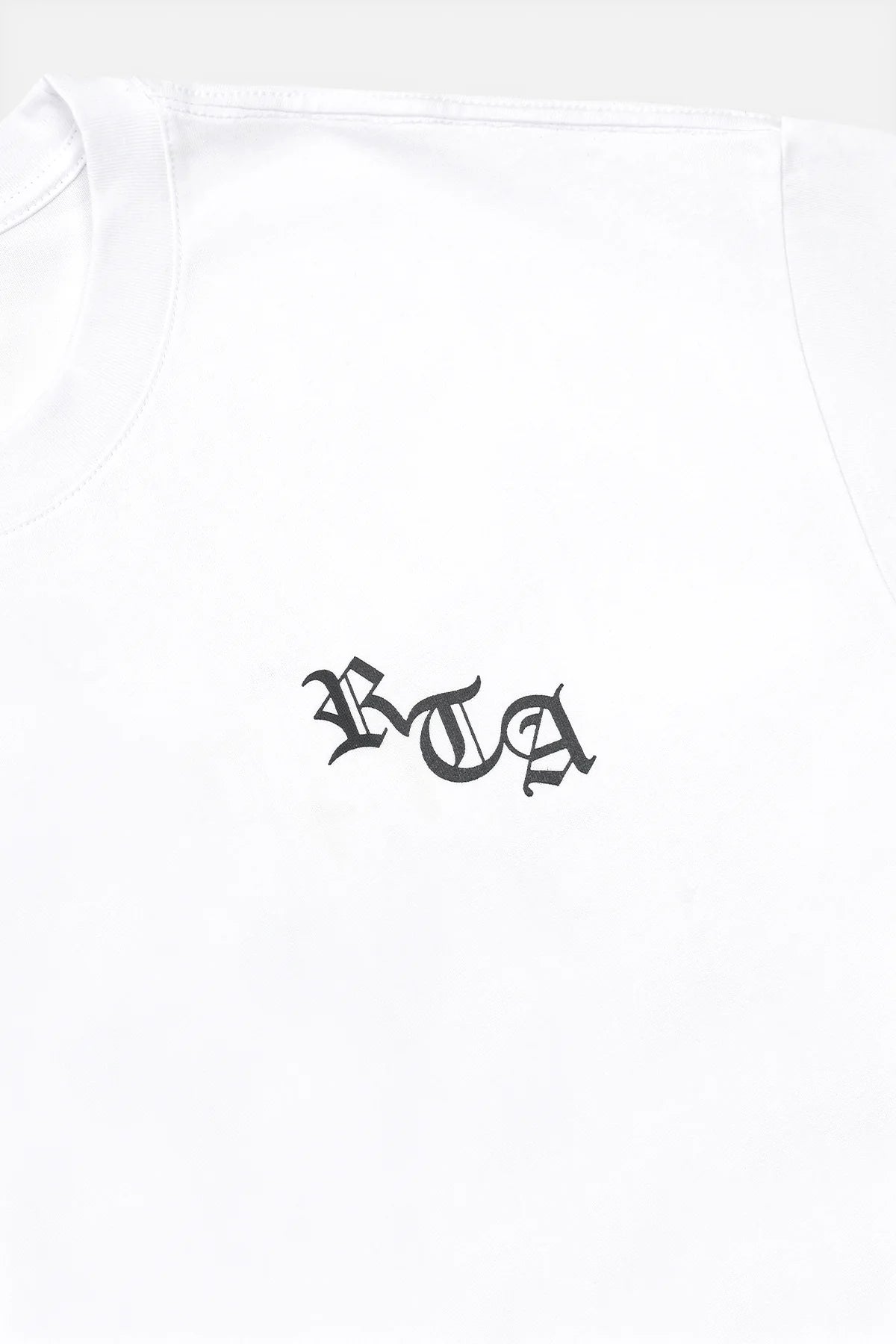 RtA Colin Oversized Short Sleeve Tee in White with Old English logo on chest and New York cross motif on back