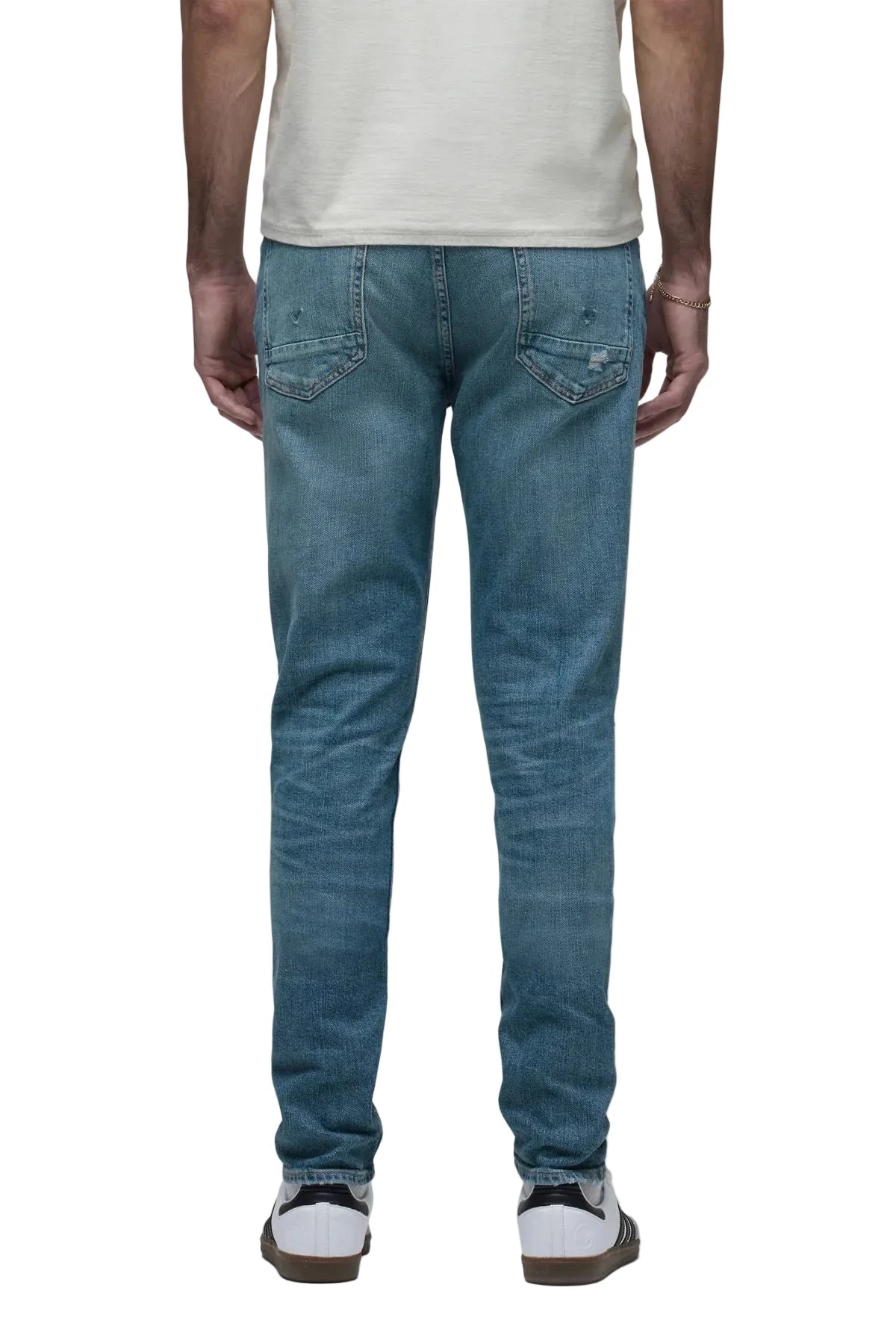 Zack Skinny Jeans in Canal medium indigo rigid denim with distressed knee details and a modern slim-fit silhouette.
