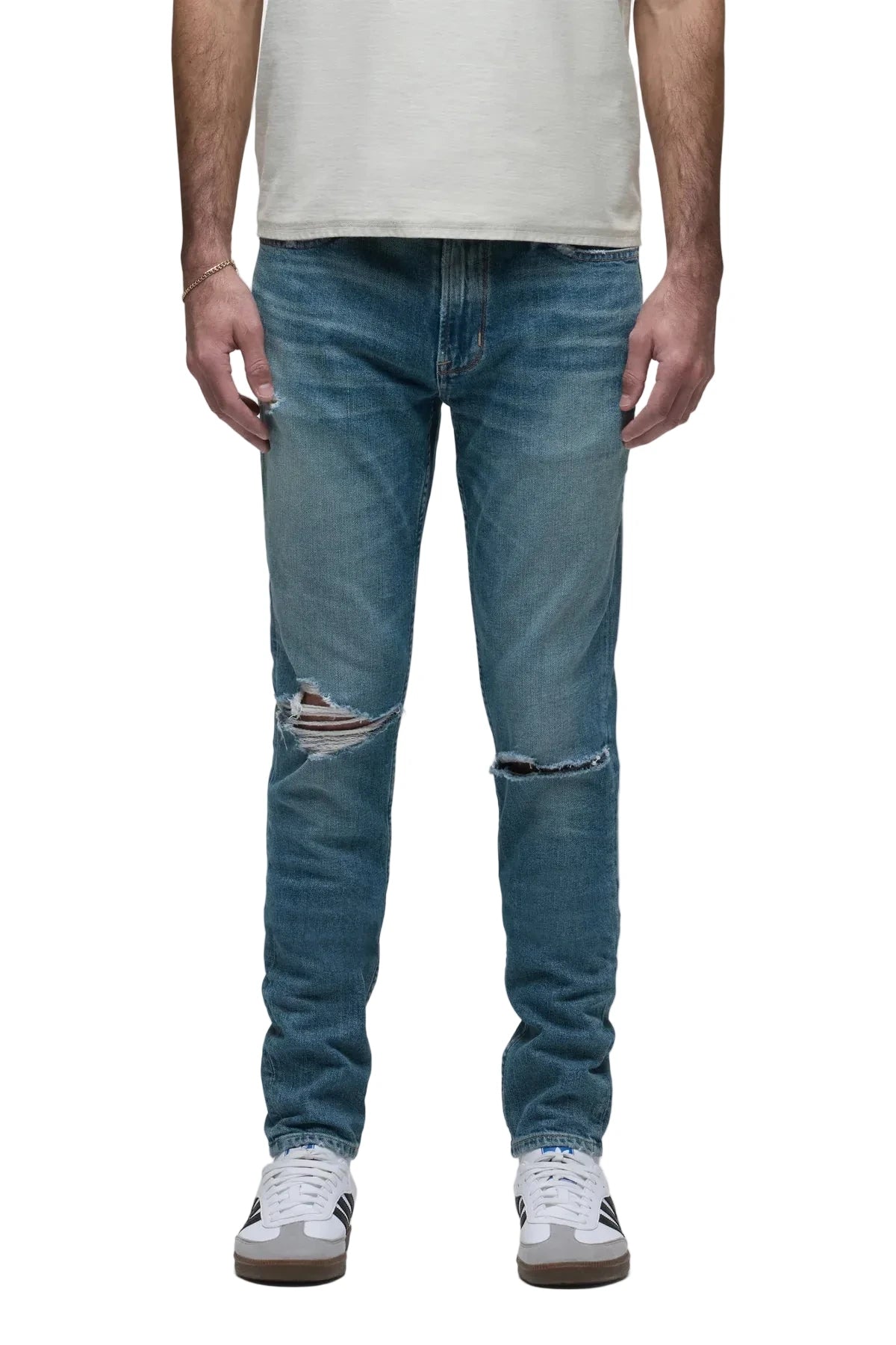 Zack Skinny Jeans in Canal medium indigo rigid denim with distressed knee details and a modern slim-fit silhouette.