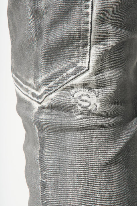 "SERENEDE® TIBURON jeans with grey overspray on white base, carpenter-style design, and unique artistic finish."