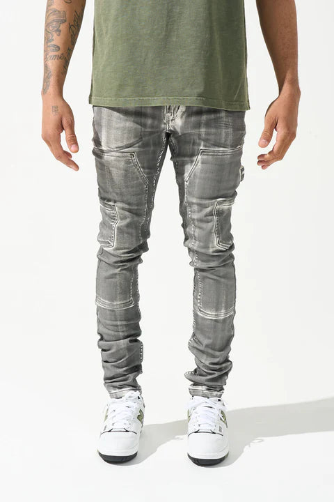 "SERENEDE® TIBURON jeans with grey overspray on white base, carpenter-style design, and unique artistic finish."