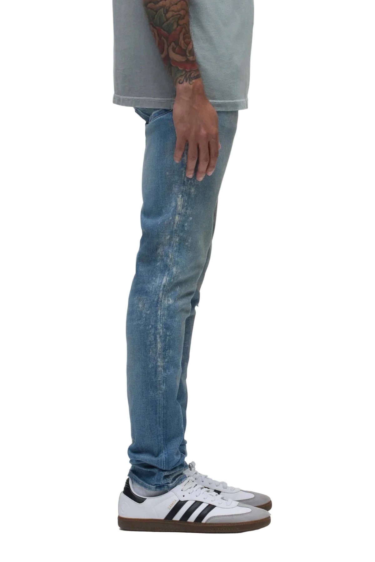 Hudson Zack Skinny Jeans in Ocean Ave medium indigo wash with distressing, pigment splatter details, and a modern skinny-fit silhouette.