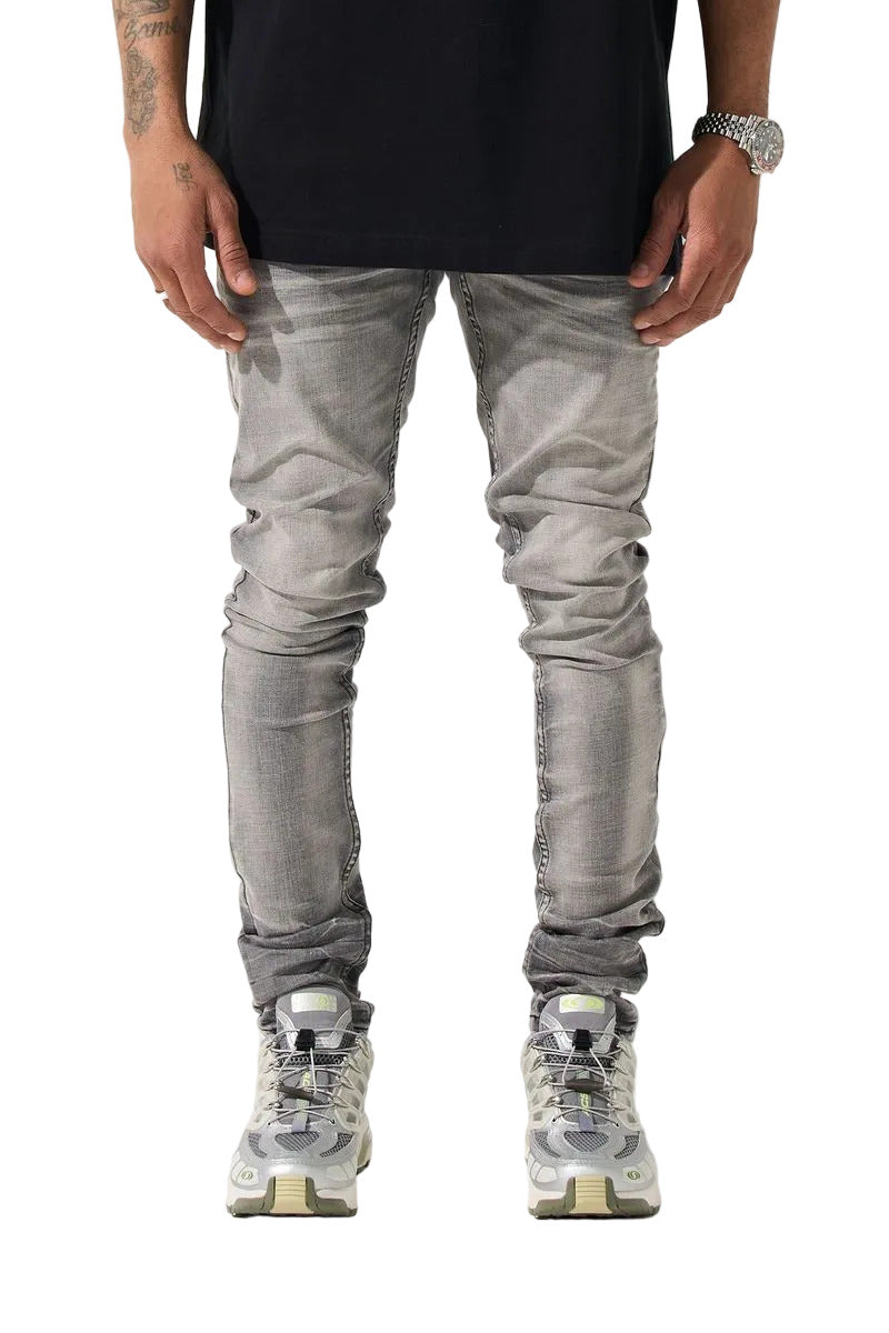 SERENEDE® TITAN skinny jeans in faded grey wash with five-pocket styling, tonal stitching, and leather logo waistband patch.