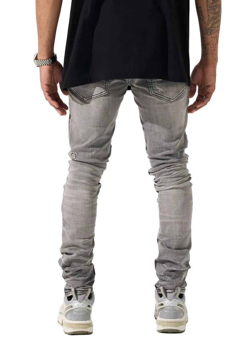 SERENEDE® TITAN skinny jeans in faded grey wash with five-pocket styling, tonal stitching, and leather logo waistband patch.