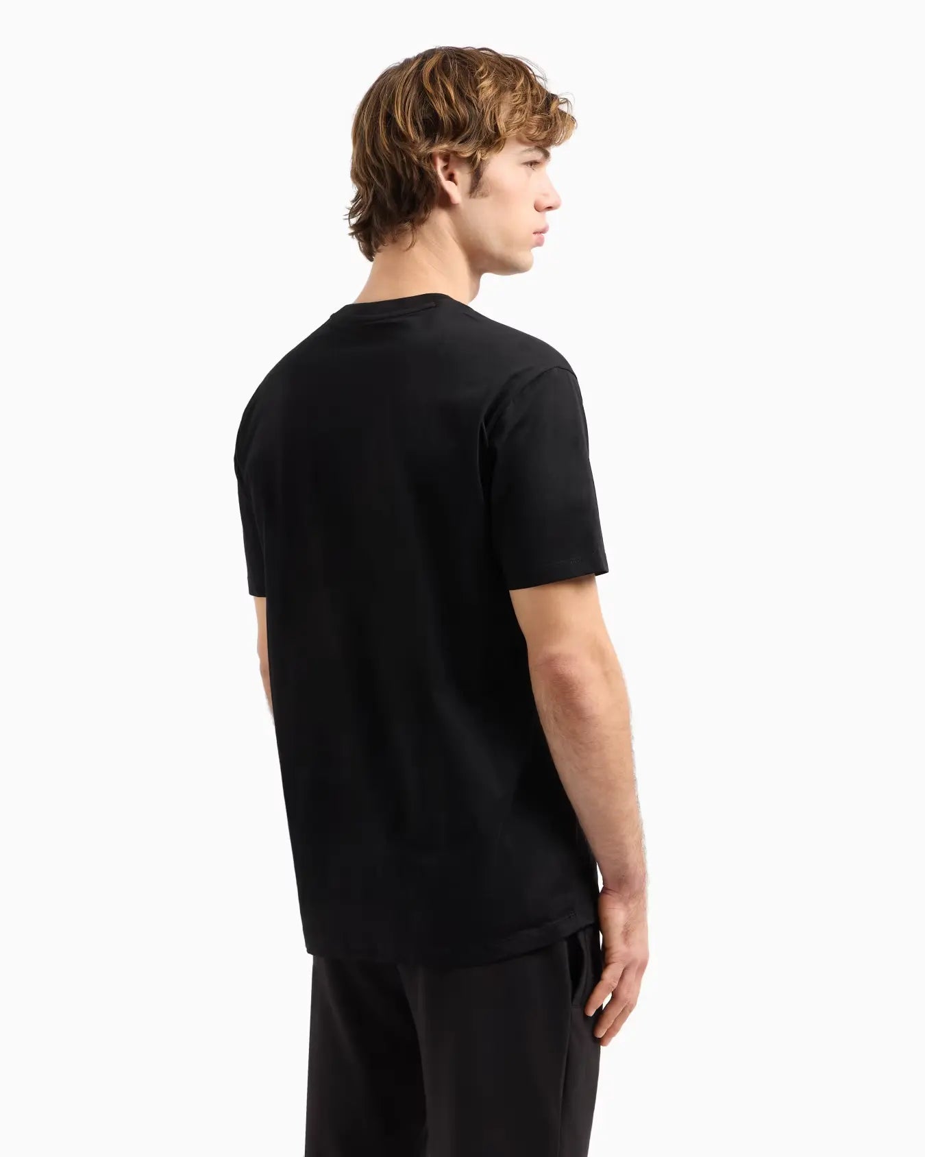 Person wearing a black t-shirt on a white background