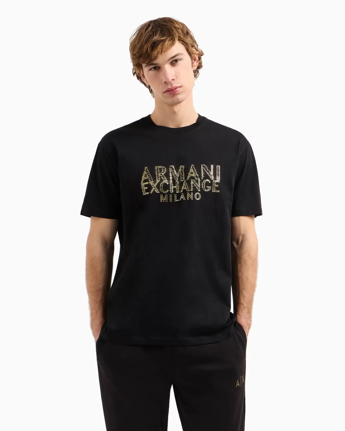 Person wearing a black Armani Exchange t-shirt on a white background