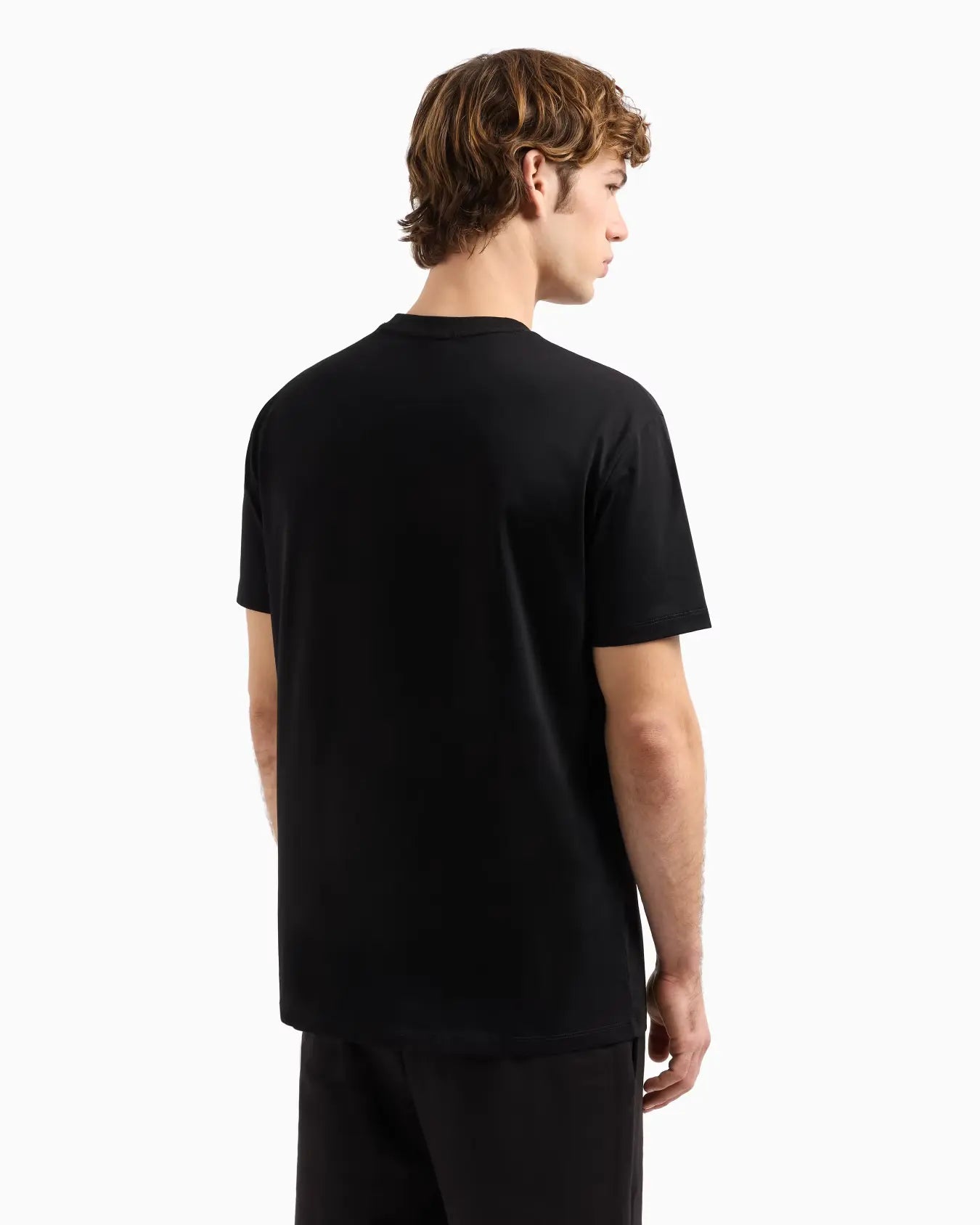 Person wearing a black t-shirt on a white background