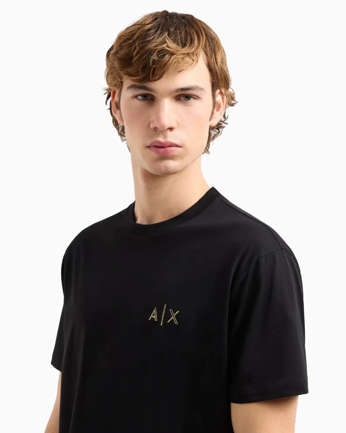 Person wearing a black t-shirt with a logo on a white background