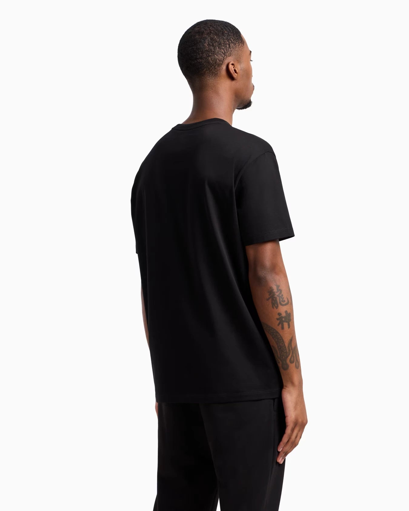 Person wearing a black t-shirt on a white background