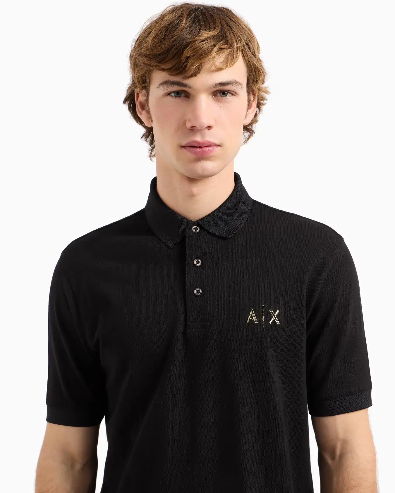 Man wearing a black polo shirt with a logo on a white background