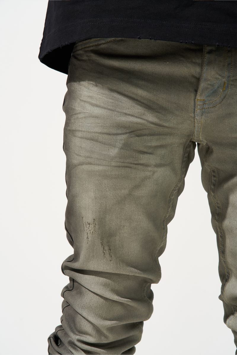 SERENEDE® ZINC stacked jeans in shade grey with charcoal spray stripes, hand-painted details, and fitted stacked silhouette.