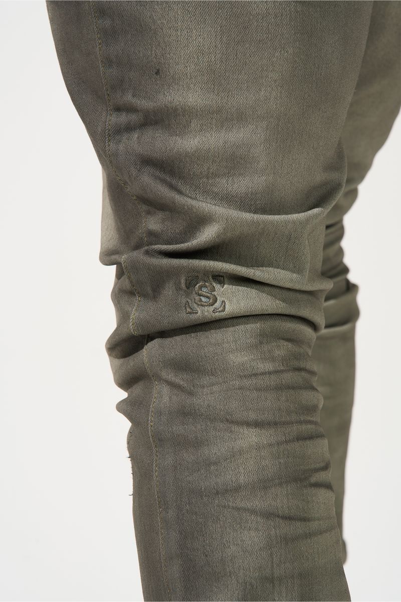 SERENEDE® ZINC stacked jeans in shade grey with charcoal spray stripes, hand-painted details, and fitted stacked silhouette.