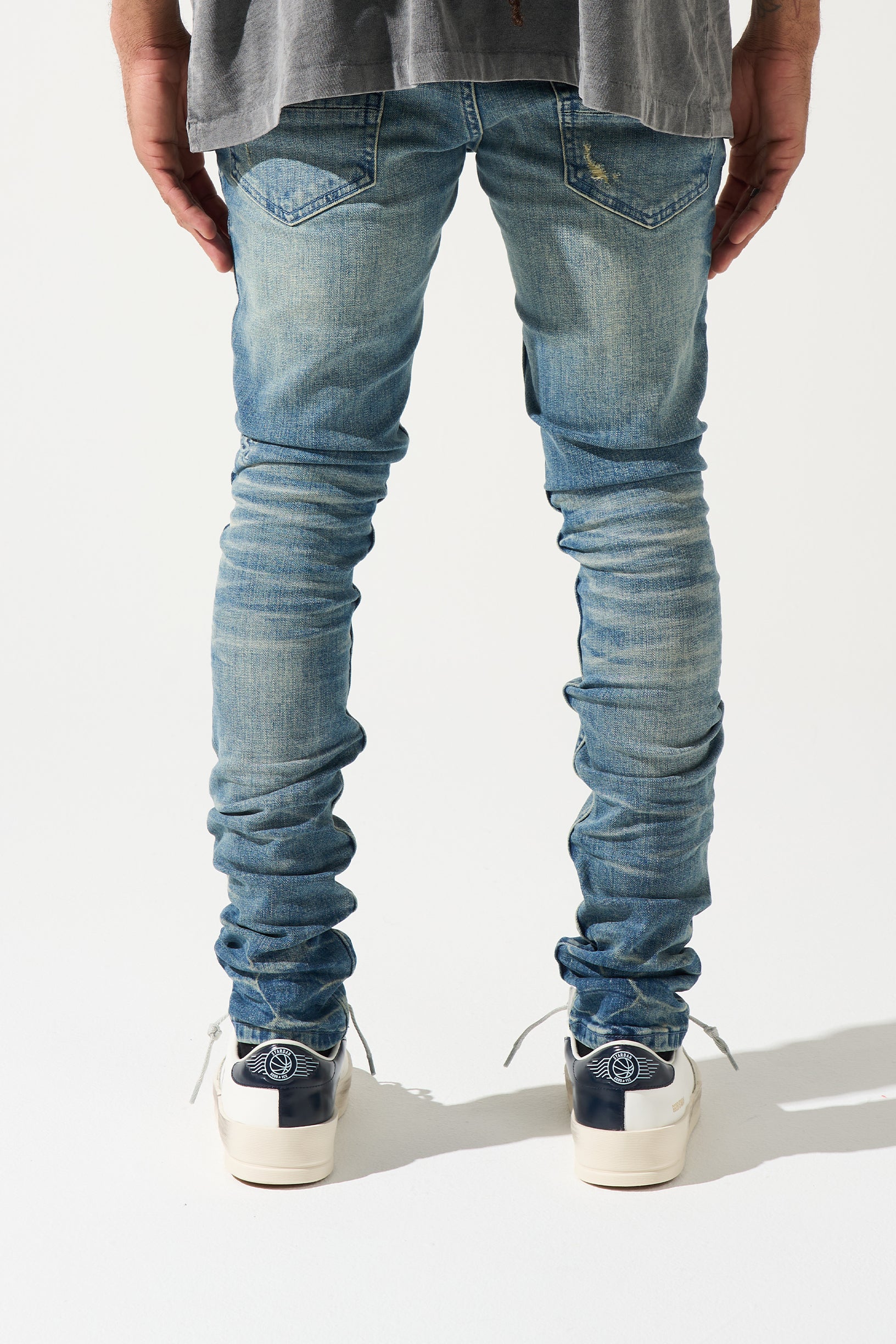 SERENEDE® Neptune Jeans in mid blue with fitted silhouette and branded hardware for streetwear style.