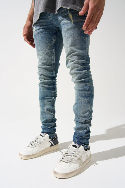 SERENEDE® Neptune Jeans in mid blue with fitted silhouette and branded hardware for streetwear style.