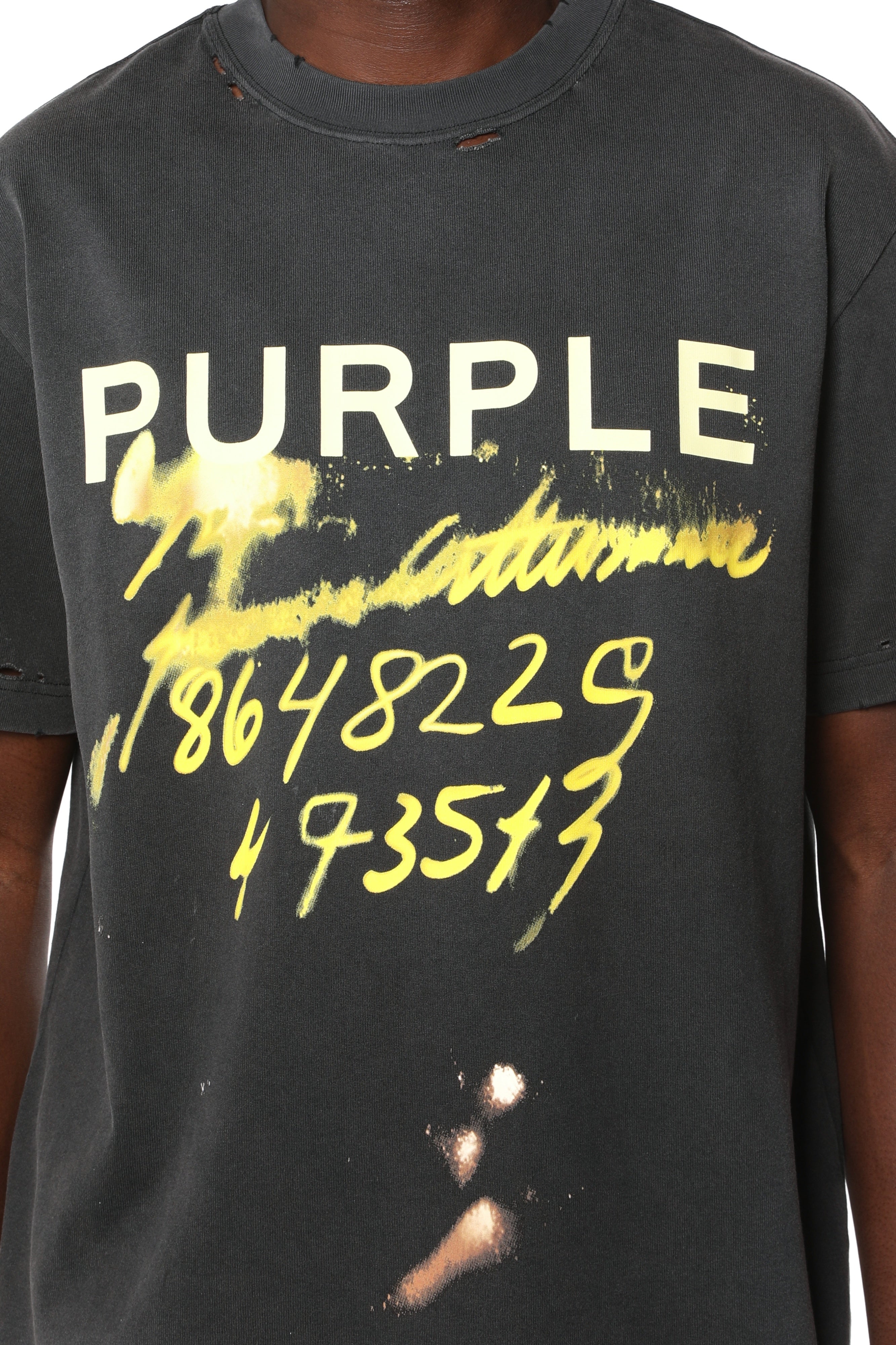 Purple Brand heavyweight cotton graphic T-shirt featuring a distressed finish with nicks, holes, heavy fading, bleach stains, and neon graphic detailing.